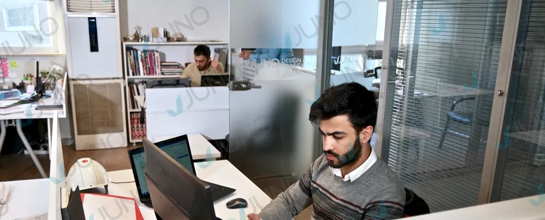 Team member working at a computer in the Juno office